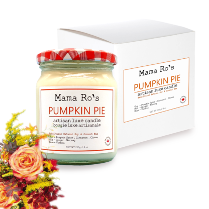 pumpkin pie candle jar beside white gift box and bouquet of fall flowers